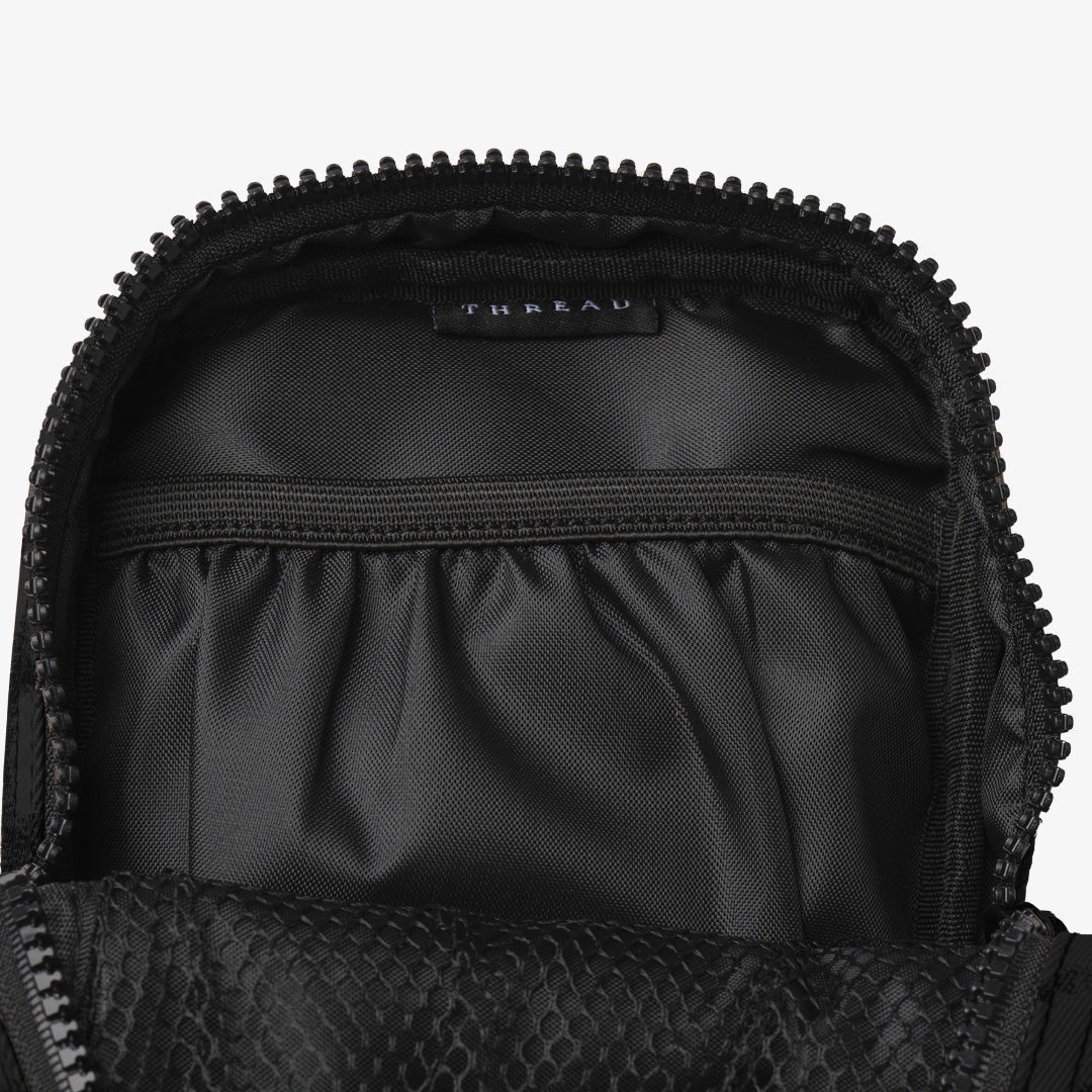 Inside of the Thread® Black crossbody bag showing pockets and printed lining