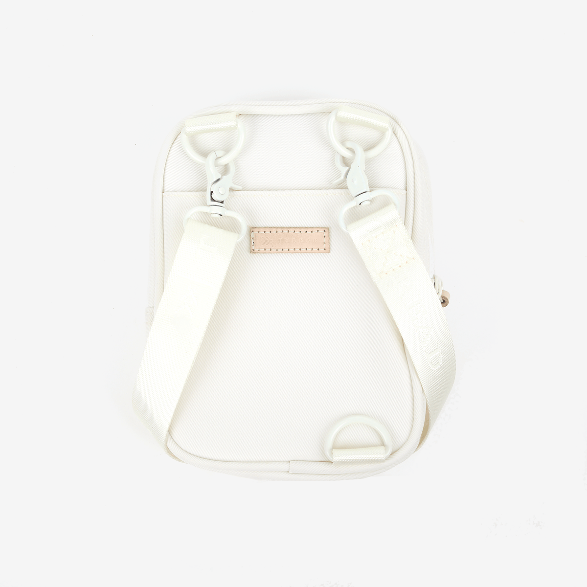 Inside of the Thread® Off White crossbody bag showing pockets and printed lining