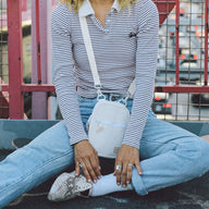 Person wearing the Thread® Off White crossbody bag across the chest